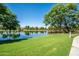 Scenic community pond with a pier and grassy shoreline at 4711 E Buckboard Ct, Gilbert, AZ 85297