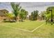 Well-kept community volleyball court with mature trees and nearby residences at 4711 E Buckboard Ct, Gilbert, AZ 85297