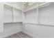 Bright walk-in closet featuring white shelving and metal rods for maximum storage at 4711 E Buckboard Ct, Gilbert, AZ 85297