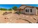 Wide backyard shot showcasing a brick patio, a built-in grill, desert landscaping, and privacy block wall at 5320 E Silverbell Rd, San Tan Valley, AZ 85143