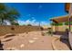 Spacious backyard featuring a charming brick patio, built-in grill, block wall, and desert landscaping at 5320 E Silverbell Rd, San Tan Valley, AZ 85143