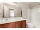 Bathroom featuring a single sink with dark wood counters and a shower-tub combo at 5320 E Silverbell Rd, San Tan Valley, AZ 85143