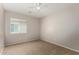Bedroom with neutral walls, carpet, ceiling fan, and a view of the window at 5320 E Silverbell Rd, San Tan Valley, AZ 85143