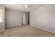 This bedroom is carpeted and features a ceiling fan and a large window at 5320 E Silverbell Rd, San Tan Valley, AZ 85143