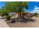 Attractive single-story home featuring a two-car garage, desert landscaping, and privacy wall at 5320 E Silverbell Rd, San Tan Valley, AZ 85143