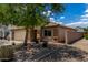 Attractive single-story home featuring a two-car garage, desert landscaping, and privacy wall at 5320 E Silverbell Rd, San Tan Valley, AZ 85143