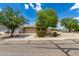 Inviting single-Gathering home featuring a two-car garage, desert landscaping, and a neutral color scheme at 5320 E Silverbell Rd, San Tan Valley, AZ 85143
