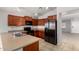 Kitchen featuring stainless steel appliances, tile flooring, wood cabinets, and lots of counter space at 5320 E Silverbell Rd, San Tan Valley, AZ 85143