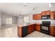 Well-lit kitchen offering dark appliances, ample counter space and an open view into the living area at 5320 E Silverbell Rd, San Tan Valley, AZ 85143