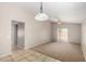 Spacious living area with tile entry, carpet, and sliding glass doors for seamless indoor-outdoor living at 5320 E Silverbell Rd, San Tan Valley, AZ 85143