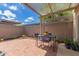 Covered brick patio with outdoor dining area and simple landscaping at 541 N Lesueur St, Mesa, AZ 85203