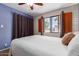 Bright bedroom boasting a textured accent wall and large window views at 541 N Lesueur St, Mesa, AZ 85203