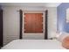 Bedroom featuring a textured brick wall with a shuttered window at 541 N Lesueur St, Mesa, AZ 85203
