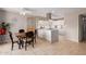Bright kitchen and dining area with tiled floors, white cabinets, and modern appliances at 541 N Lesueur St, Mesa, AZ 85203
