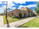 Exterior shot of a well-maintained brick home with a sidewalk and palm trees at 541 N Lesueur St, Mesa, AZ 85203