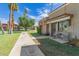 Exterior shot of a well-maintained brick home with a small sitting area and lawn at 541 N Lesueur St, Mesa, AZ 85203