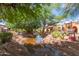 Enjoy serene greenbelt views complete with mature shade trees, lush greenery, and trickling stream at 541 N Lesueur St, Mesa, AZ 85203