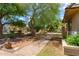 Stroll the peaceful greenbelt with mature trees and lush landscaping throughout community at 541 N Lesueur St, Mesa, AZ 85203