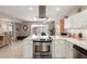 Bright kitchen showcasing stainless steel appliances, white cabinets, and open layout to dining area at 541 N Lesueur St, Mesa, AZ 85203