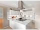 Modern kitchen with white cabinets, granite countertops, and stainless steel range hood at 541 N Lesueur St, Mesa, AZ 85203