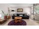 Inviting living room with stylish decor, tile flooring, and a comfortable black leather sofa at 541 N Lesueur St, Mesa, AZ 85203