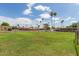 Community playground on a grassy lawn with mature trees and swing sets for outdoor fun at 541 N Lesueur St, Mesa, AZ 85203