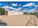 Community fenced tennis court area lined with tall palm trees, perfect for outdoor activities at 541 N Lesueur St, Mesa, AZ 85203
