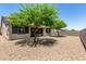 Spacious backyard featuring desert landscaping and mature trees at 5519 N 187Th Ln, Litchfield Park, AZ 85340