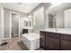 Spacious bathroom boasts dual vanities, a soaking tub, tile floors, and neutral color scheme at 5519 N 187Th Ln, Litchfield Park, AZ 85340