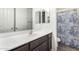 Bathroom featuring a vanity with modern faucet and a shower/tub combination with a patterned curtain at 5519 N 187Th Ln, Litchfield Park, AZ 85340