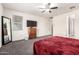 Spacious bedroom with a ceiling fan, a window and vintage dresser offers ample space for living at 5519 N 187Th Ln, Litchfield Park, AZ 85340
