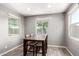 Bright dining area features a wood table with chairs, and a view to the outside through the large windows at 5519 N 187Th Ln, Litchfield Park, AZ 85340