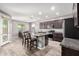 Spacious kitchen featuring a granite-topped island, stainless appliances, and tile flooring with a dining area at 5519 N 187Th Ln, Litchfield Park, AZ 85340