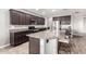 Well-lit kitchen boasts granite countertops, stainless steel appliances, and a functional island with bar seating at 5519 N 187Th Ln, Litchfield Park, AZ 85340