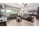 Bright living room showcasing comfortable seating, a ceiling fan, and a seamless flow into the kitchen and dining area at 5519 N 187Th Ln, Litchfield Park, AZ 85340
