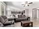 Inviting living room with plush seating, modern ceiling fan, and easy access to the kitchen, perfect for entertaining at 5519 N 187Th Ln, Litchfield Park, AZ 85340