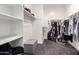 A walk-in closet with built-in shelves and ample hanging space provides plenty of storage at 5519 N 187Th Ln, Litchfield Park, AZ 85340