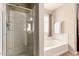 Clean bathroom featuring glass enclosed shower, separate tub, and a neutral color scheme at 5840 E Holmes Ave, Mesa, AZ 85206