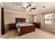 Bedroom featuring ceiling fan, neutral carpet, and two side tables with lamps at 5840 E Holmes Ave, Mesa, AZ 85206