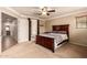 Bedroom with ceiling fan, connecting doors, and view into bathroom at 5840 E Holmes Ave, Mesa, AZ 85206