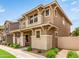 Charming two-story home with a welcoming front porch, complemented by lush landscaping and neighborhood street at 5840 E Holmes Ave, Mesa, AZ 85206