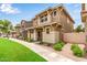 View of stylish homes with front porches, manicured landscaping, sidewalks, and beautiful blue sky in a pleasant neighborhood at 5840 E Holmes Ave, Mesa, AZ 85206