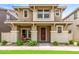 Inviting two-story home featuring a cozy front porch, complemented by a well-maintained lawn and desert landscaping at 5840 E Holmes Ave, Mesa, AZ 85206