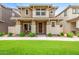 Charming two-story home with a manicured lawn, covered porch, and neutral color palette in a residential neighborhood at 5840 E Holmes Ave, Mesa, AZ 85206