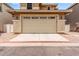 Attached two-car garage with decorative windows and ample parking space on a sunny day at 5840 E Holmes Ave, Mesa, AZ 85206