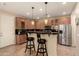 Well-appointed kitchen with a bar area, stainless steel appliances, and ample cabinet space for culinary enthusiasts at 5840 E Holmes Ave, Mesa, AZ 85206