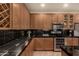 Kitchen with granite counters, stainless steel appliances, and custom wood cabinetry at 5840 E Holmes Ave, Mesa, AZ 85206