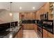 Well-lit kitchen featuring granite countertops, stainless steel appliances, and custom cabinets at 5840 E Holmes Ave, Mesa, AZ 85206