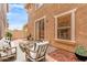 Charming patio features stylish outdoor furniture, brick pavers, and sliding glass door access at 5840 E Holmes Ave, Mesa, AZ 85206