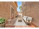 Narrow patio features stylish outdoor furniture, brick pavers, and exterior access at 5840 E Holmes Ave, Mesa, AZ 85206